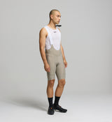 Side profile of pumice men's cycling bib shorts – breathable Superfit fabric and side stash pockets for gravel and road riding utility