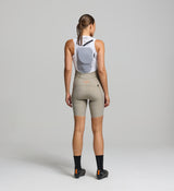 Back view of women’s bib shorts with hydration pack pocket and hose channel – built for gravel, road, and multi-hour cycling adventures