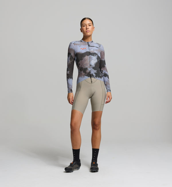Front view of female cyclist wearing light purple long sleeve jersey – breathable high-stretch woven fabric with ergonomic performance fit