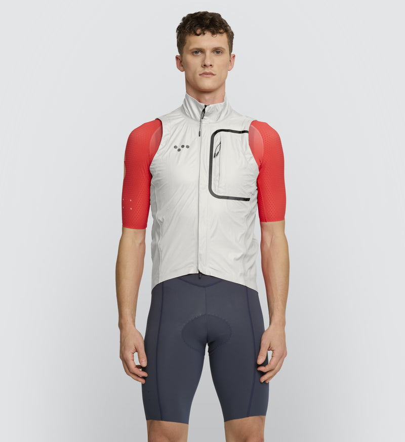 Cyclist wearing the Chalk Pro Deflect Gilet, featuring a windbreaker design with a high stand collar for optimal protection against winter weather.
