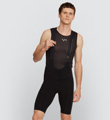 Front view of model wearing Pro Men's SuperFit Air Bib Shorts in Black, showcasing a sleek brace system and compressive fit for muscle support and reduced drag during intense road cycling sessions.