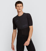 Front view of model wearing Pro Men's Velocity Cycling Jersey in Black, showcasing a race-ready anatomical fit with aerodynamic fabric, YKK auto-lock zipper, and mesh back for enhanced breathability and comfort during intense rides.