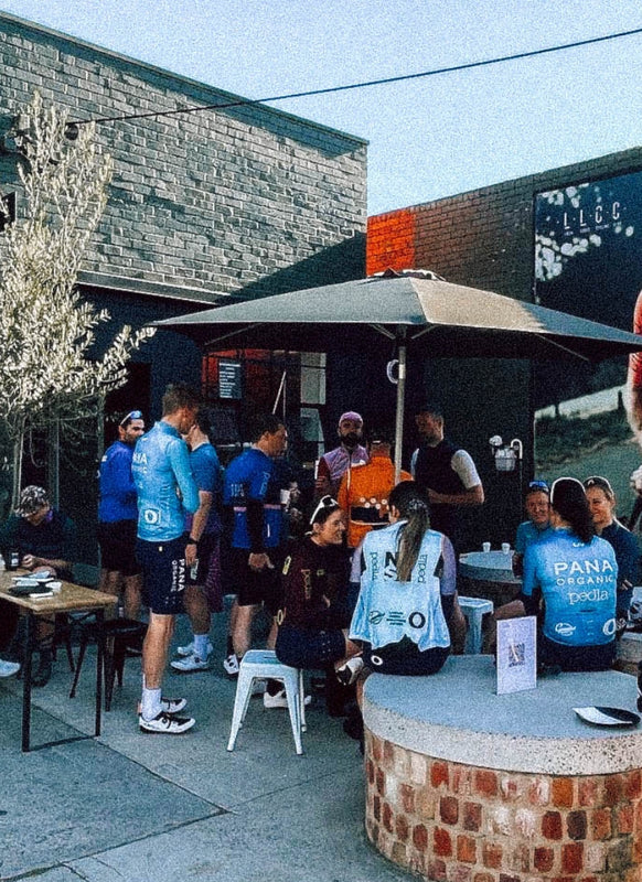 Group of Cyclists eating and drinking outside Pedla Shop